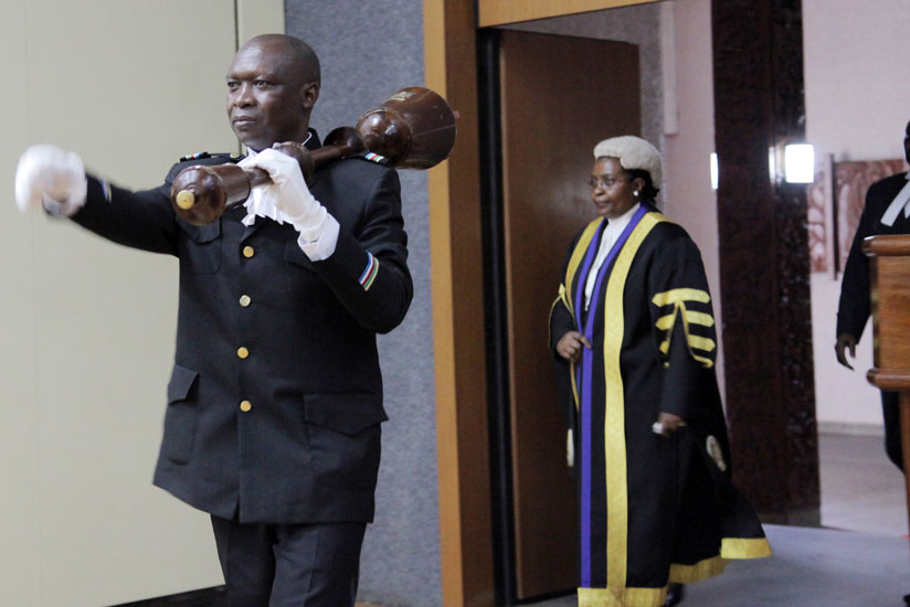 The sergeant at arms ushers in the former Eala speaker Margaret Zziwa during a session in Kigali last October. (John Mbanda)