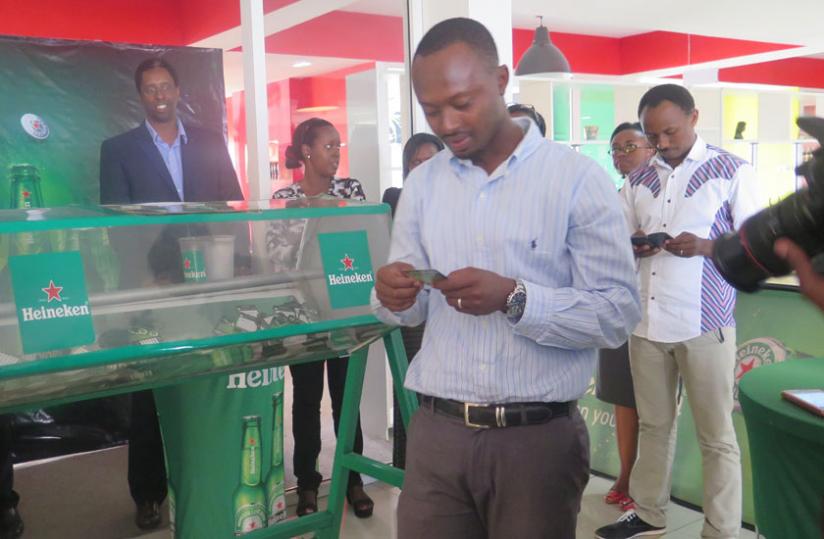 The previous winner of the Heineken Cities Campaign, John Muhoza, reads out the name of one of the winners. (Stephen Kalimba)
