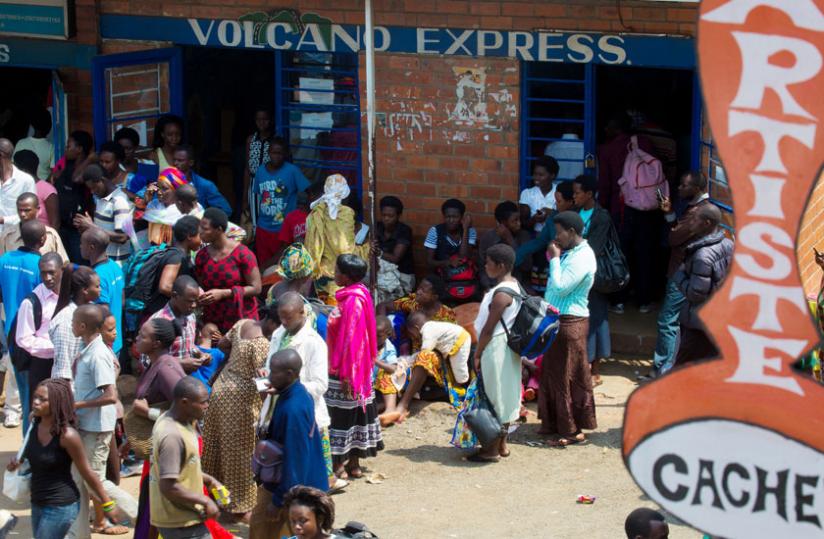 Passengers stranded in Nyabugogo bus terminal yesterday waiting for omnibuses . (T.Kisambira)