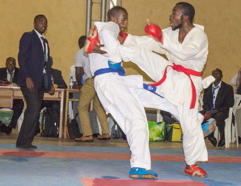 Lions' Laurent Barawigirira, (R), and UR's Vanily Ngarambe, clash in a fierce final of the Kumite under 75kg which Ngarambe won. (Fernand Mugisha)