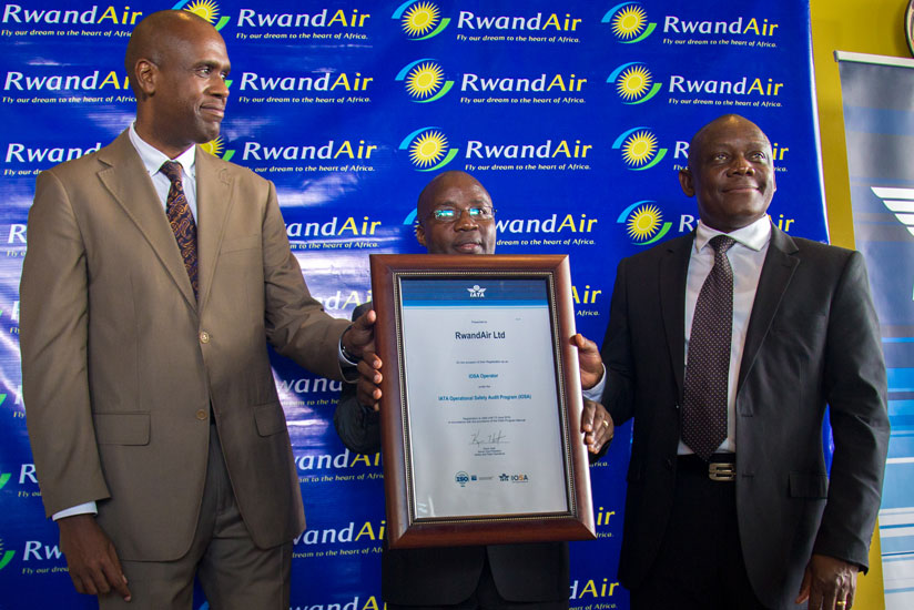 State minister in charge of Transport Dr.Alexis Nzahabwanimana (centre) and RwandAir CEO John Mirenge (left) after receiving a certificate from International Air Transport Association vice-president for Africa Raphael Kuuchi (right) recently. (Timothy Kisambira )