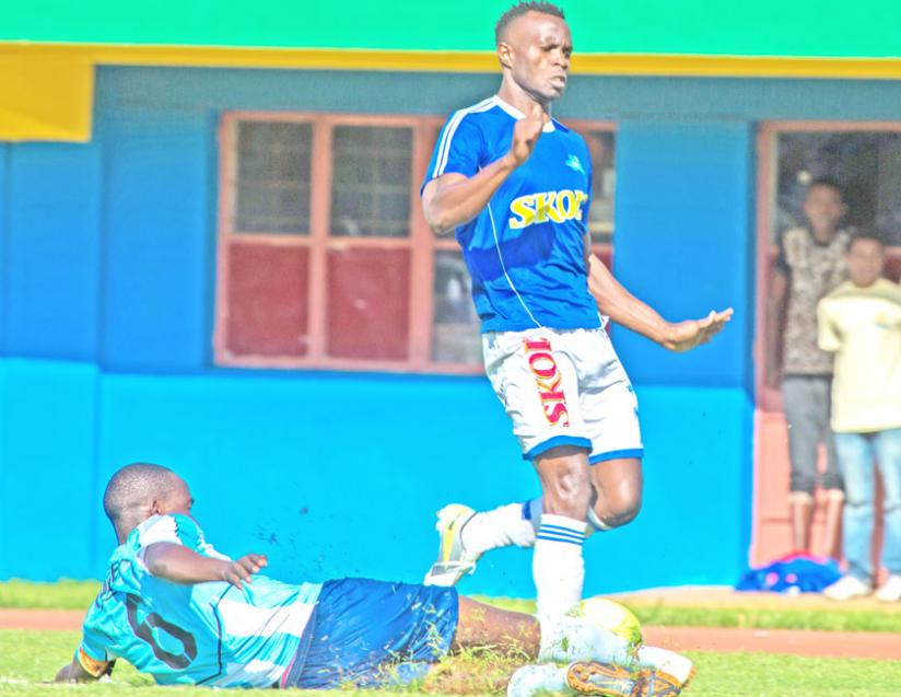 Rayon Sportu2019s top scorer Peter Otema jumps out of a slidding tackle by Police FC skipper Fabrice Twagizimana the last time the two teams met in December. (Timothy Kisambira)