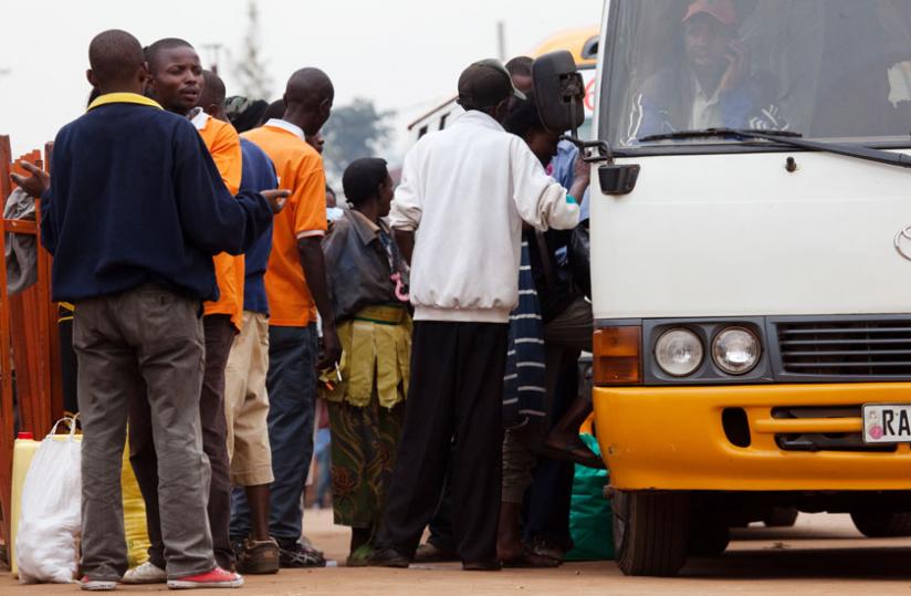 Passengers board an Omnibus at Nyabugogo bus terminal last week. (Timothy Kisambira)