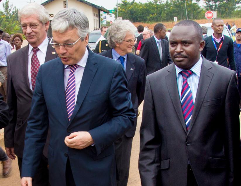 Reynders (L) and Bugesera mayor Louis Rwagaju walk into the offices of Nemba one-stop border post yesterday. The Belgian minister said his country has not suspended aid. (Timothy Kisambira)