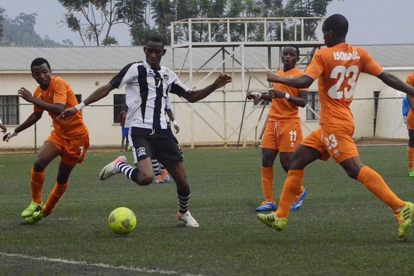APR midfielder Jean Baptiste Mugiraneza tries to get past a host of Isonga defenders during a league game recently.  (Sam Ngendihimana)