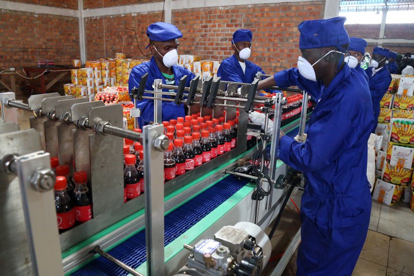 Crystal Bottling Company employees at work. (John Mbanda)