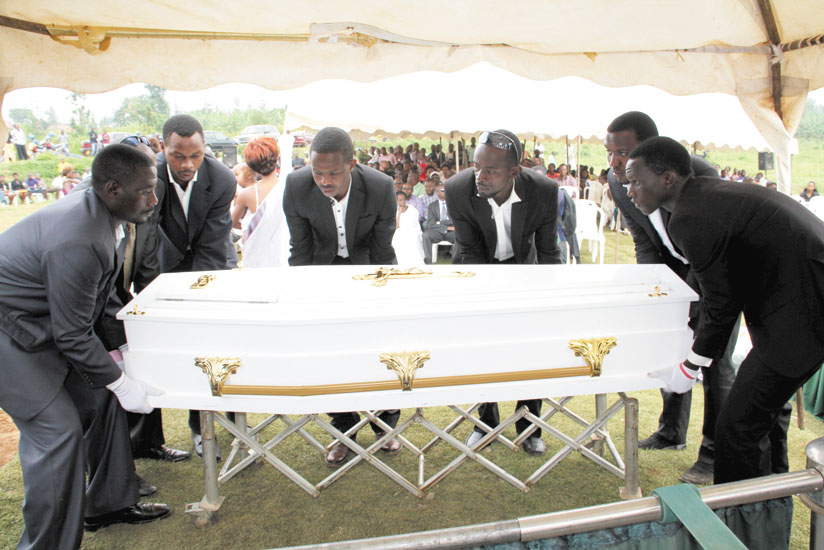 Fare the well. A casket containing the body of Jean Claude Gasigwa is lowered in the graveyard at Rusororo Cemetery. (Pontian Kabeera)