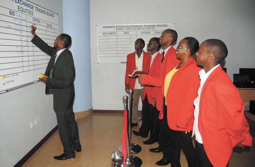 Traders during an earlier session at the local bourse. The ALSI shed 1.04 points to close at 135.79 points yesterday. (File)