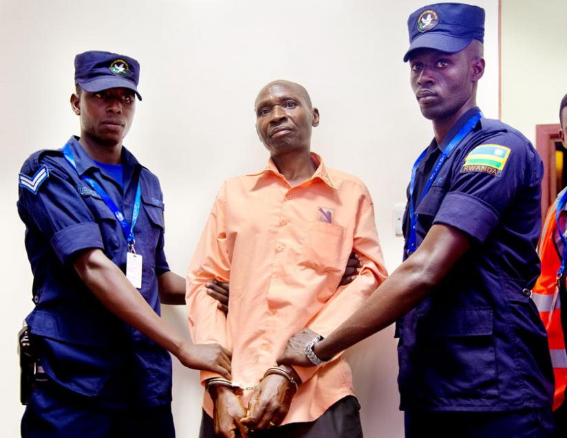 Genocide suspect Jean Paul Birindabagabo is officially arrested by Rwanda National Police after being deported from Uganda yesterday. (T. Kisambira)