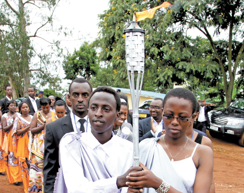 Youth carry the commemoration flame in Kicukiro District on its last leg of a countrywide tour last year.  (File)