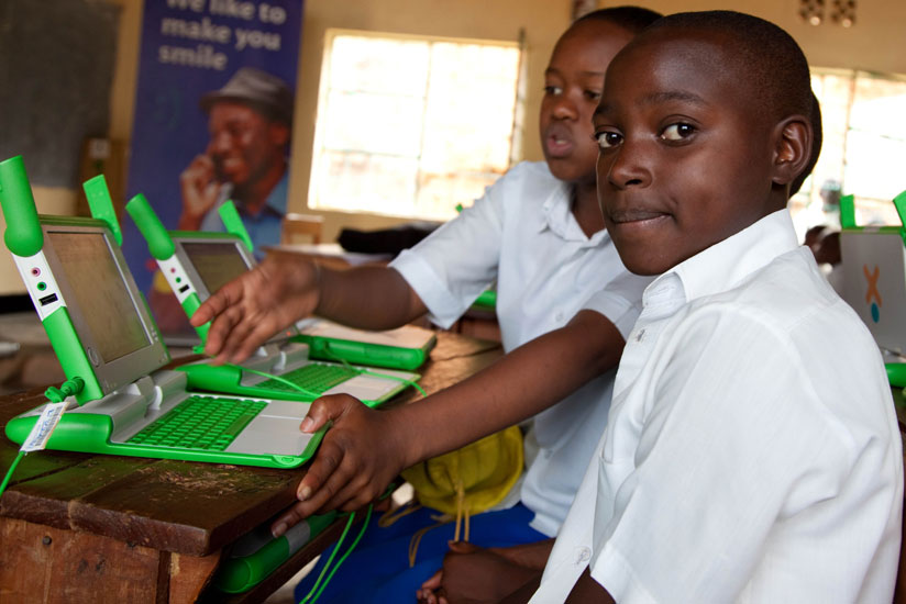 Pupils of Kimisagara Primary School use their laptops acquired under the One-Laptop-Per-Child project. (Timothy Kisambira) 