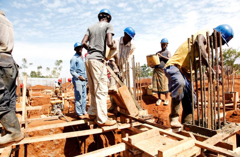 Workers at a construction site in Kigali in 2013. Authorities in Gasabo District have recalled construction permits issued between 2012 and 2014 over allegations of fraudulent issuance. (File)