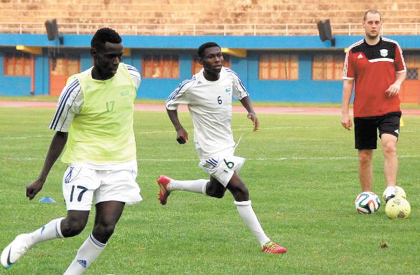 Amavubi Interim coach Lee Johnson (R) takes the national team through training drills recently. (Courtesy)