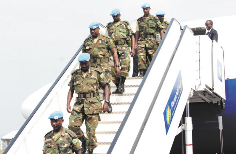 RDF peacekeepers alight from a RwandAir plane on arrival at Kigali International Airport yesterday. (Courtesy)