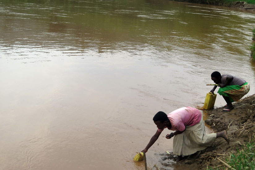 Girls fetch water from Nyabarongo River recently. (File)