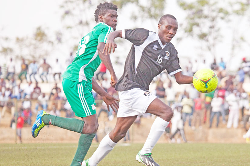 Tumaine 'Titi' Ntamuhanga in (right) tries to go past a Kiyovu defender during the Peace Cup last season. He has joined Police on a six month loan deal. (File)