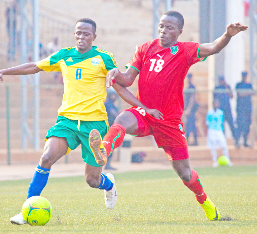 Amavubi captain Haruna Niyonzima (left) tries to edge past a Malawian defender during an Afcon qualifier. (File)