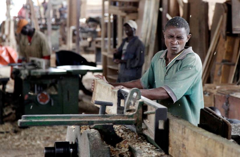 A carpenter in a workshop in Gakinjiro in Kigali. The National Labour Council has asked Mifotra to expedite the approval of the proposed minimum wage law. (File)