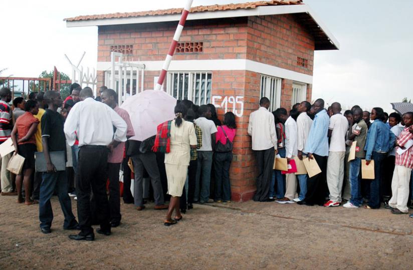 Job seekers queue to deposit their applications at a company reception in Kigali in 2009. (File)