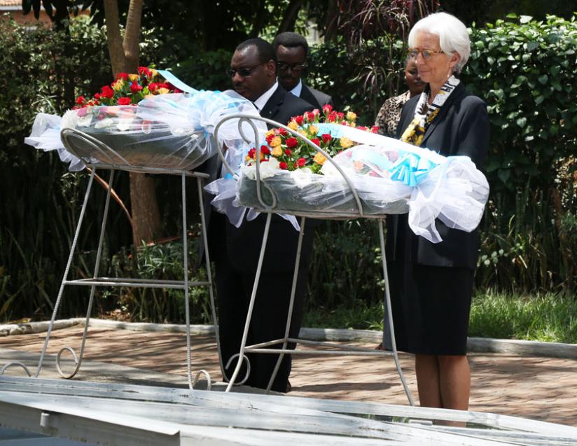 Lagarde (right), with Finance minister Claver Gatete, lays a wreath on one of the mass graves at Kigali Genocide memorial, yesterday. (John Mbanda)