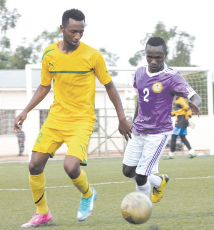 AS Kigali striker Justin Mico (L) vies for the ball against a Sunrise defender during yesterday's league match which ended 1-1 at Kigali regional stadium. (Sam Ngendahimana)
