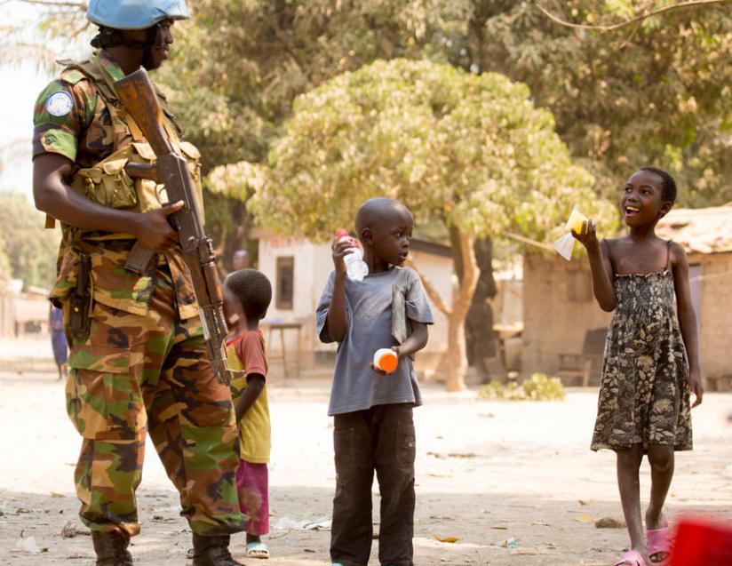 An RDF peacekeeper interacts with children in Bangui. (Timothy Kisambira)