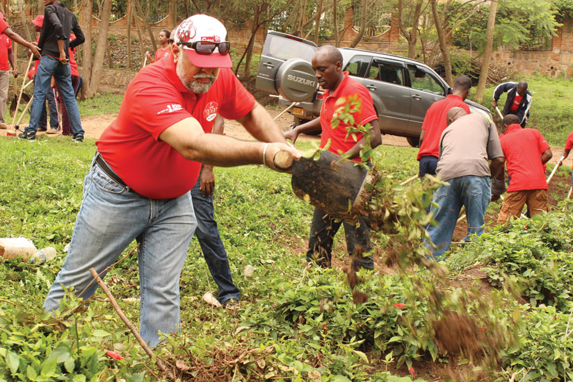 Airtel chief, Teddy Bhullar (left),  and the telecom's staff participate in the monthly community service (Umuganda) last year. It is important for organisations to support community initiatives to remain relevant and win people's goodwill. (File)