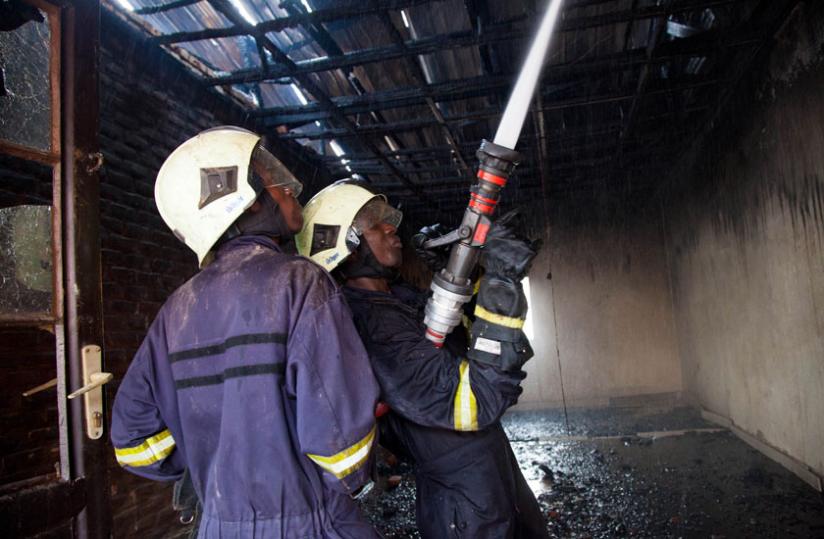 Fire fighters extinguish fire in Nyabugogo on July 14 last year. (Timothy Kisambira)