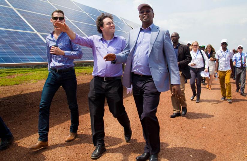 Chaim Motzen, co-founder and managing director of Gigawatt Global (C) shows Infrastructure minister James Musoni (R) and Trevor Green, the managing director of Remote Partners, around the new solar photovoltaic power plant in Rwamagana District yesterday.(Timothy Kisambira)