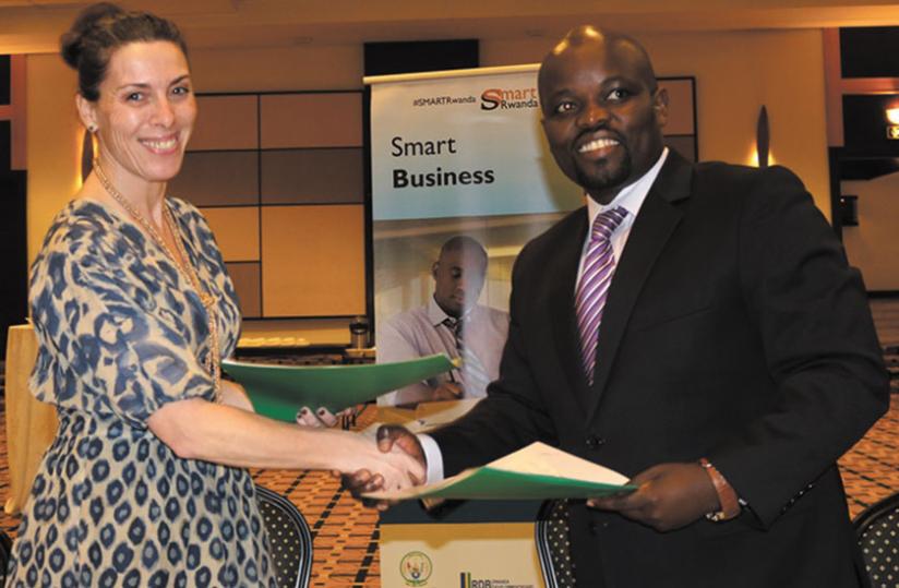 Mauro and Nsengimana shake hands after signing the deal yesterday in Kigali. (Ivan Ngoboka)