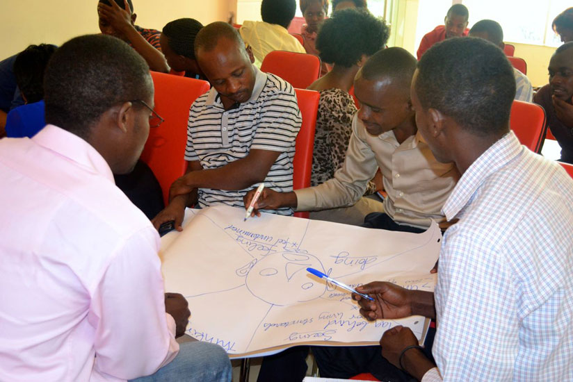 Participants analyse a business plan at the workshop on Tuesday. (Mary Ingabire)
