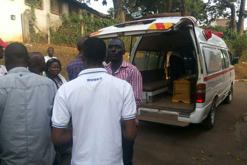 Family and friends put the caskets containing the remains of the deceased onto an ambulance in Mulago Hospital in Kampala yesterday. (Gashegu Muramira)