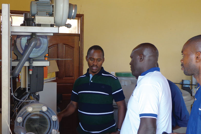 Sano (left) on a field tour of one of the water treatment plants. WASAC is looking to pump adequate water by 2017. (Courtesy)