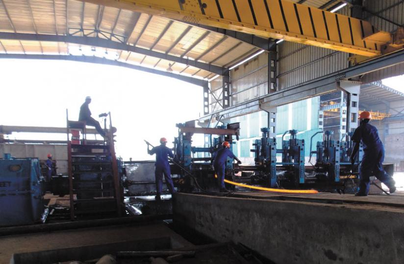 Workers fix equipment at the plant that is expected to create 300 jobs. (Courtesy)
