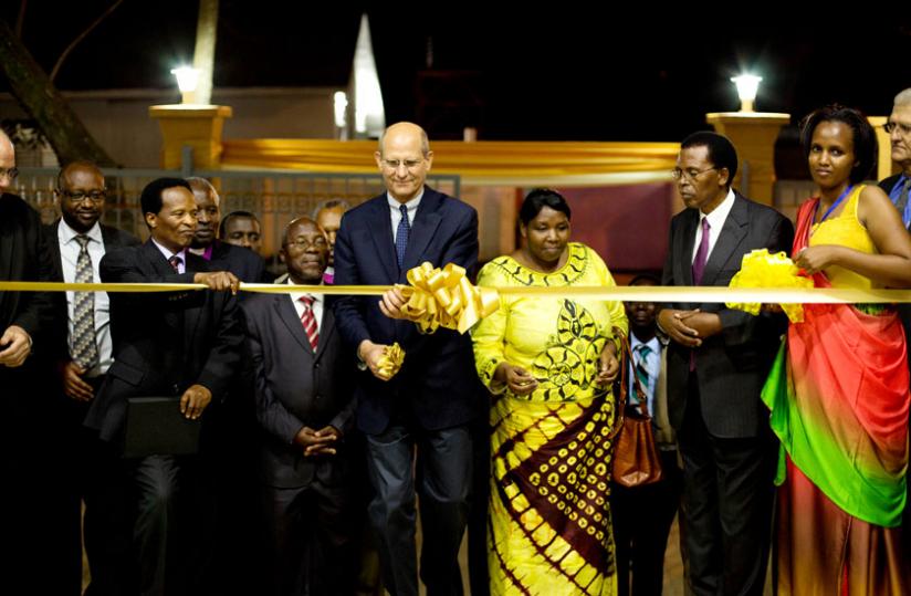 Ted Wilson, the global leader of the Seventh Day Adventist Church, cuts a ribbon to inaugurate the adventist headquaters in Kigali as guests look on Tuesday.(Courtesy)