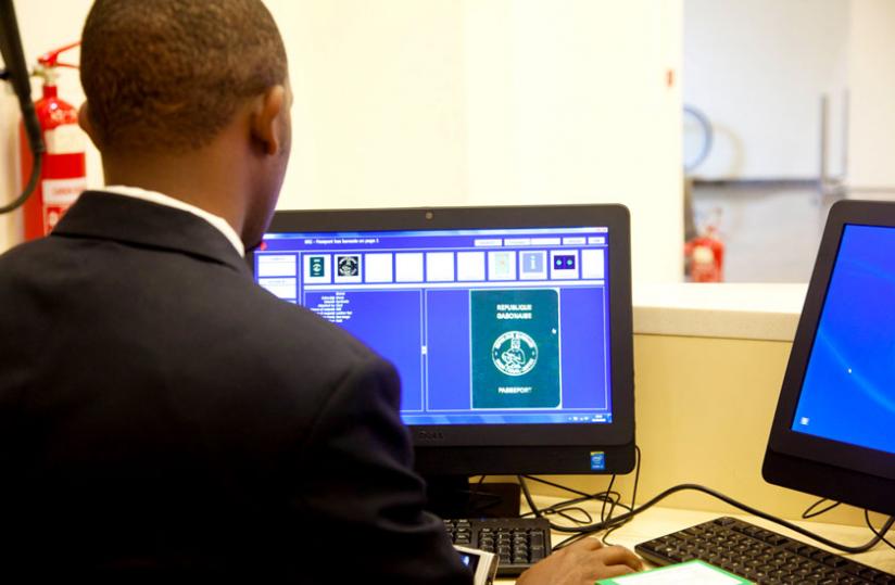 Robert SSebudandi, an IT engineer at the Kigali International Airport immigration section, demonstrates how the Edison Database Programme operates yesterday. (Doreen Umutesi)