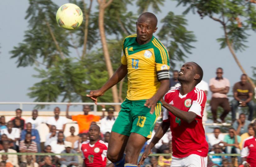 Amavubi defender Ismail 'Kodo' Nshutiyamagara heads the ball away during a friendly against Burundi. Rwanda has slipped four places in the February rankings. (File)