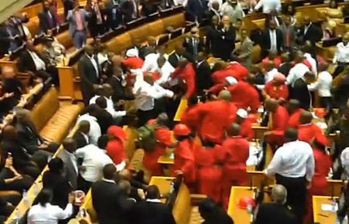 Members of the Economic Freedom Fighters are removed from parliament during President Zuma's address. 