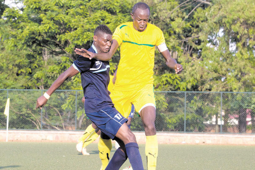 AS Kigali skipper, Muhamoud Kabura (right) battles with Police striker Emmanuel Sebanani during the first round league clash at Kicukiro stadium. (T. Kisambira)