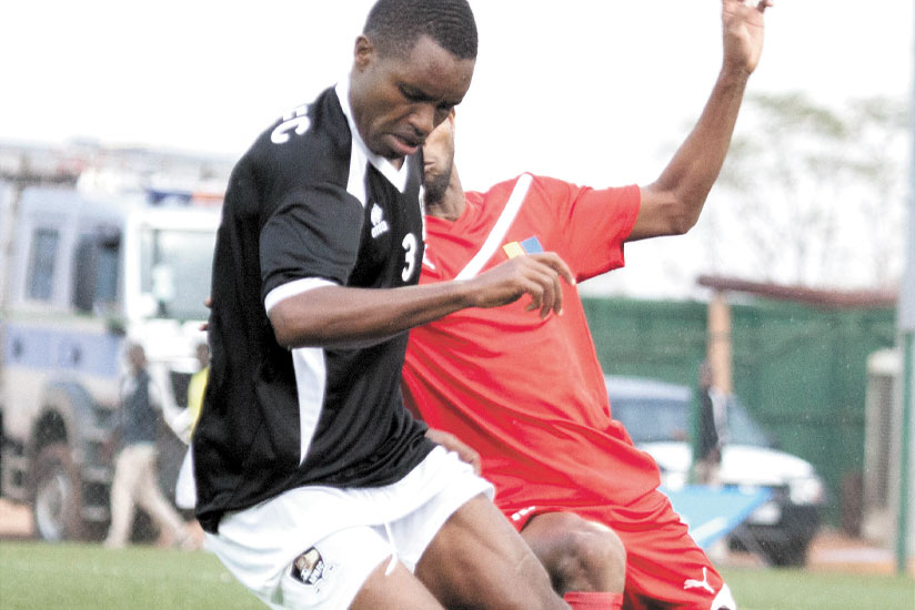 Right back, Albert Ngabo, left, shields the ball against a Djibouti Telecom opponent during last year's Cecafa Kagame Cup in Kigali. (Timothy Kisambira)