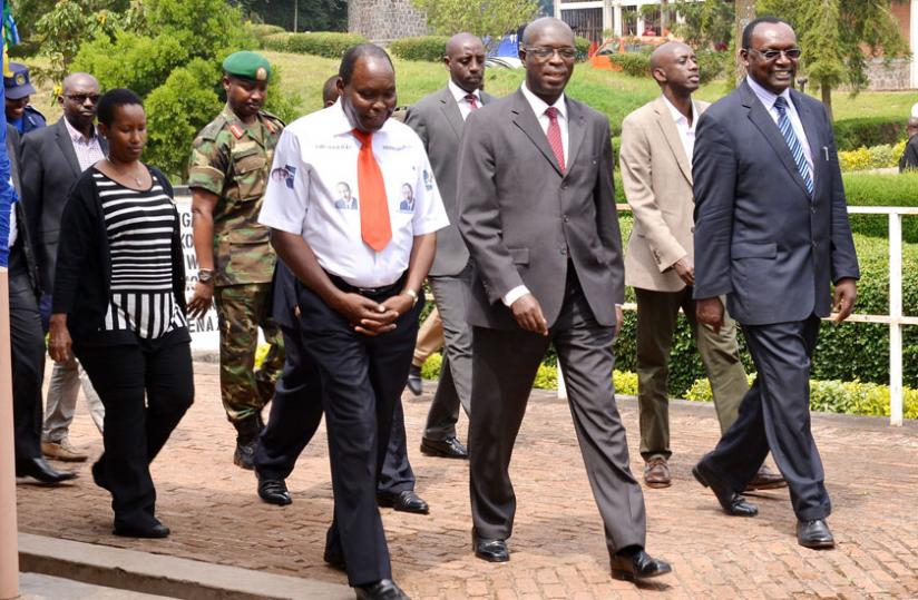 Prime Minister Anastase Murekezi (C), accompanied by Trade and Industry minister Francois Kanimba (R), Local Government minister Francis Kaboneka (behind Kanimba), and the National Itorero Commission chairperson, Boniface Rucagu (in white shirt), and other officials during the closing of Itorero for business development advisors at the National Ubutore Development Centre - Nkumba in Burera. (Jean d'Amour Mbonyinshuti)