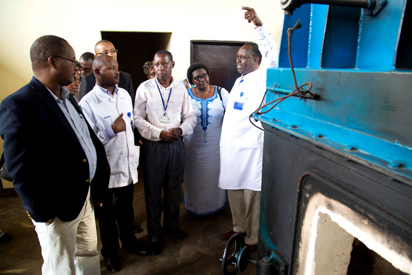 Dr. Hategekimana (R) explains to PAC members how the new incinerator at CHUK works during the legislators' assessment of the facility yesterday. (Timothy Kisambira)
