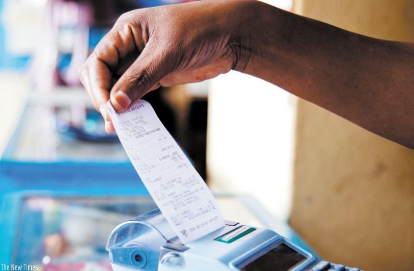 A trader pulls a receipt out of an electronic billing machine at Mateos. (File)