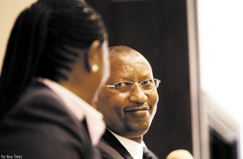 Rwagombwa (R) chats with his deputy Monique Nsanzabaganwa during the meeting in Kigali yesterday. (Timothy Kisambira)