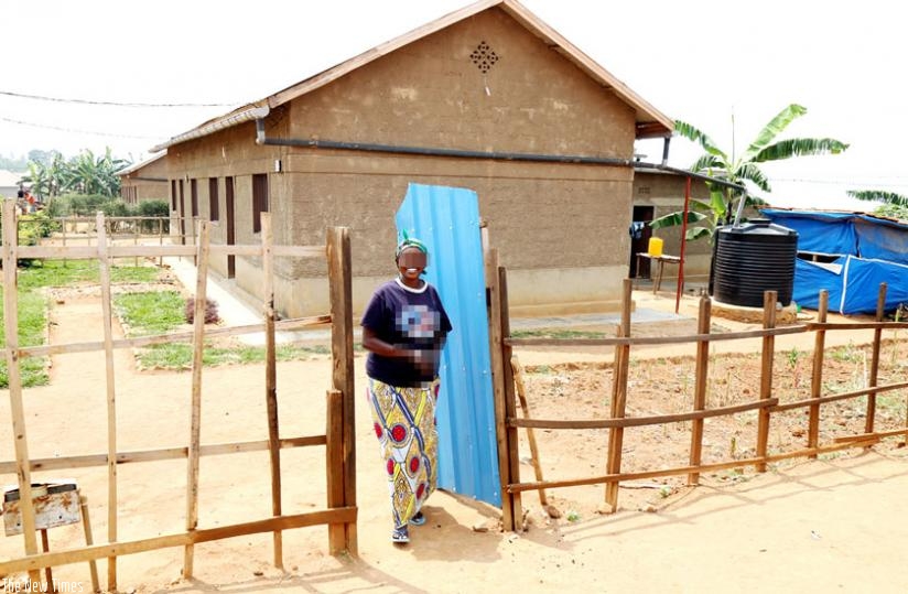'Marie' in front of her house in Kanyetabi settlement in Kicukiro. (Athan Tashobya)