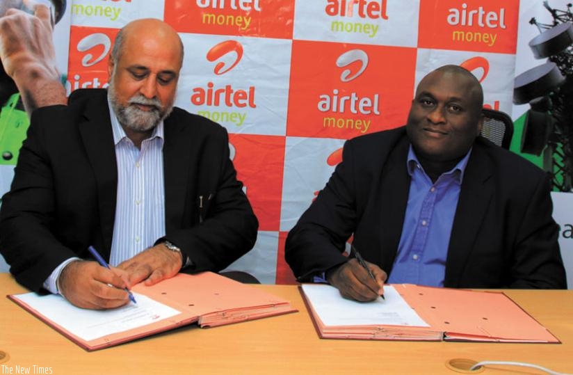 Bhullar (left) and Iluyemi during the signing of the agreement on Wednesday in Kigali. (Courtesy)