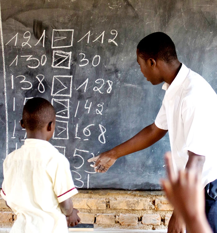 A teacher instructs a pupil at Rusheshe school. (File)