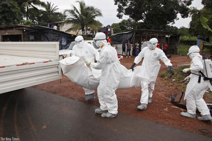 Liberian nurses remove an Ebola victim from a street on the outskirts of Monrovia Liberia last August . (Internet photo)