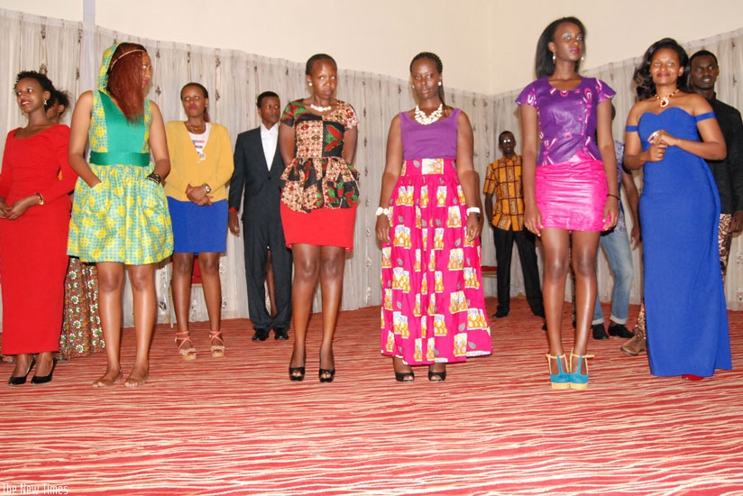 The founder of House of Shepherd fashion, Maureen Ainembabazi (wearing a long blue dress), poses for a photo with her models.