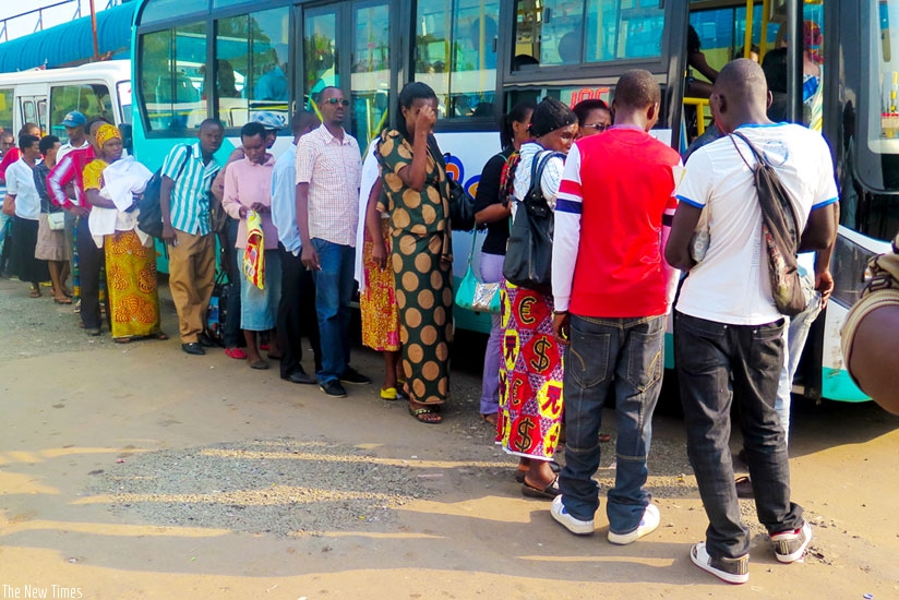 Passengers queue at a bus stop in Masaka. (File)